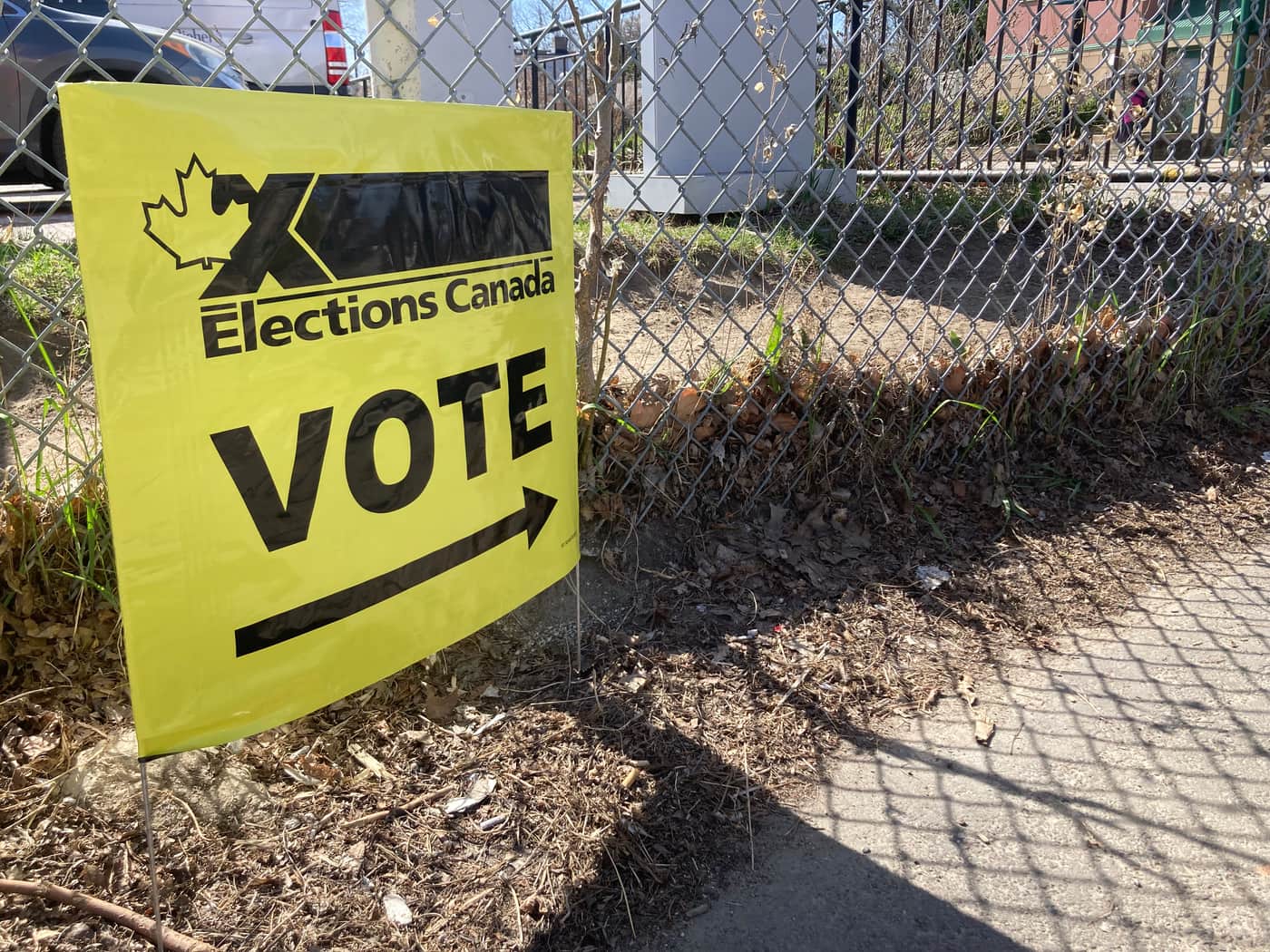 An Elections Canada 'Vote' sign pointing toward a polling station
